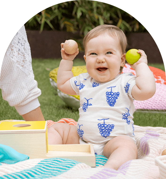 Child happily playing with the Ball Drop Box from The Inspector Play Kit