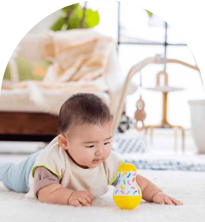 Child playing with the Tummy Time Wobbler from The Senser Play Kit